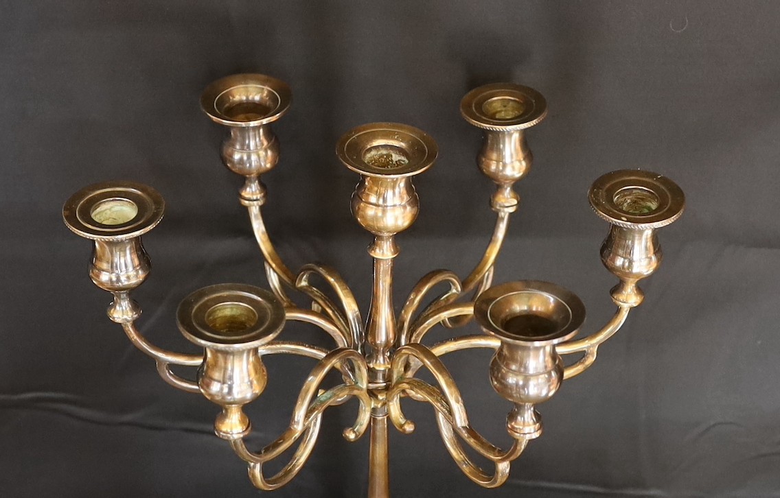 A pair of Victorian brass spiral twist candlesticks and a later seven light candelabrum, candlesticks 27cm. candelabrum 32cm